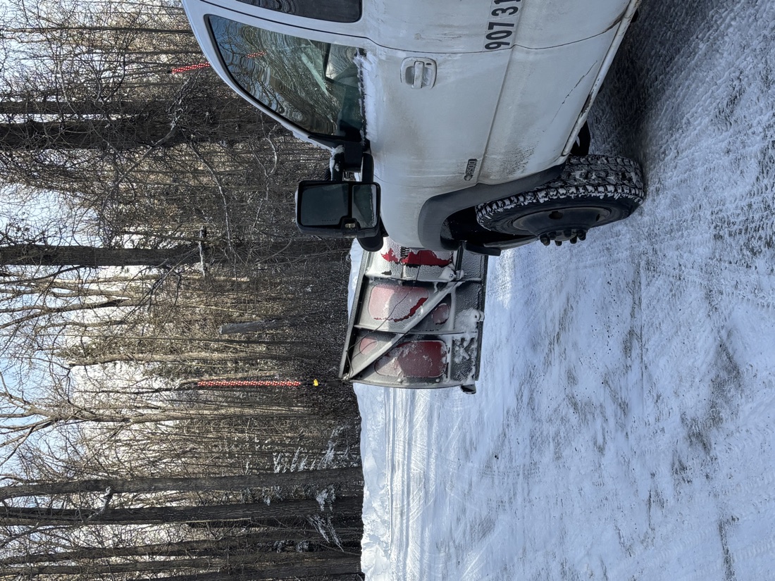 49th Enterprises LLC truck with a BOSS snow plow clearing a driveway in Palmer, Alaska